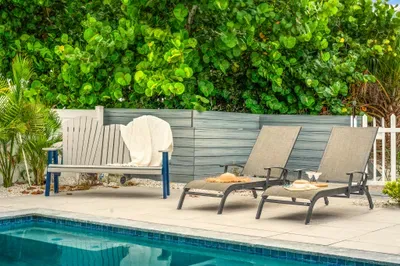 Take a break from the sun in this shaded lounge nook by the pool, the perfect balance of comfort and style.