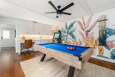 Works space, pool table, and Supercade machine.