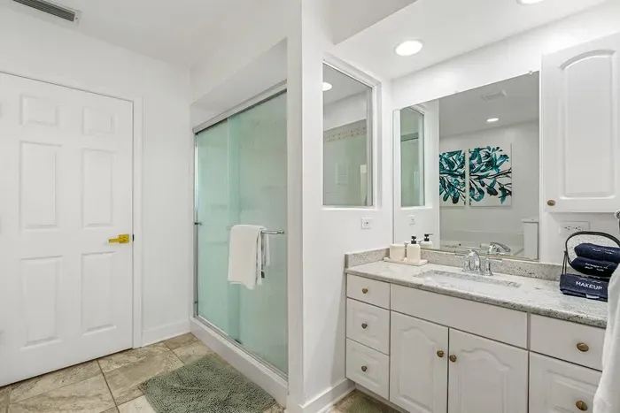 Primary bathroom with shower, jacuzzi tub, and two vanities.