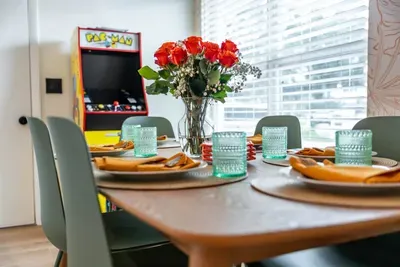 This image captures a well-lit dining area, where the soft colors of the room highlight the warmth of the wooden table.