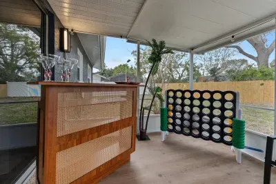 A delightful snapshot of the outdoor space, capturing the natural surroundings viewed from the cozy patio area. With modern seating and a decorative bar table, this setup encourages long conversations and relaxation amidst the tranquil atmosphere.