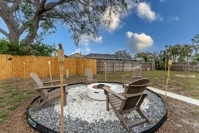 A stunning evening scene above the fire pit, as the sky transitions into vibrant hues of pink and orange at sunset. The flicker of the fire creates a warm ambiance, making it the perfect setting for memorable gatherings under the stars.
