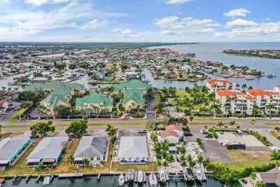 Stunning aerial setting surrounded by sparkling waterways, marinas, and vibrant coastal homes. Enjoy prime island living with easy access to beaches, boating, and breathtaking Gulf views.