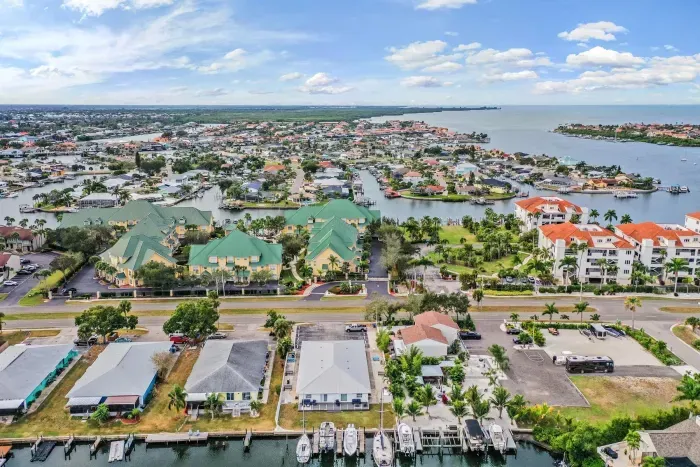 Stunning aerial setting surrounded by sparkling waterways, marinas, and vibrant coastal homes. Enjoy prime island living with easy access to beaches, boating, and breathtaking Gulf views.
