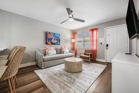 Bright, inviting living area with cozy seating, colorful décor, and warm natural light. Perfect for relaxing after a beach day, this stylish space blends comfort and charm for an unforgettable stay.