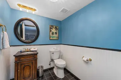 Half bath off the living room on the first floor
