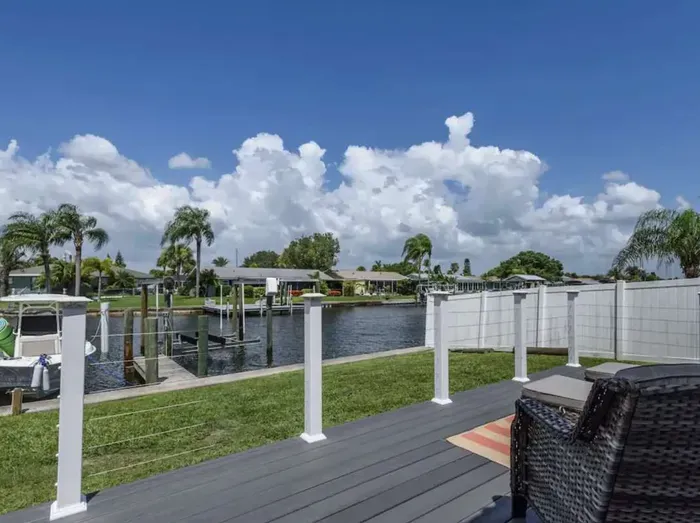 Beautiful canal-side deck offering stunning waterfront views and peaceful outdoor seating. Relax under sunny skies, watch boats drift by, or enjoy evening sunsets in this perfect coastal retreat.