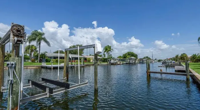 Serene waterfront view—ideal for fishing or relaxing by the water. Enjoy palm-lined scenery, gentle breezes, and tranquil canal living in this peaceful coastal getaway.