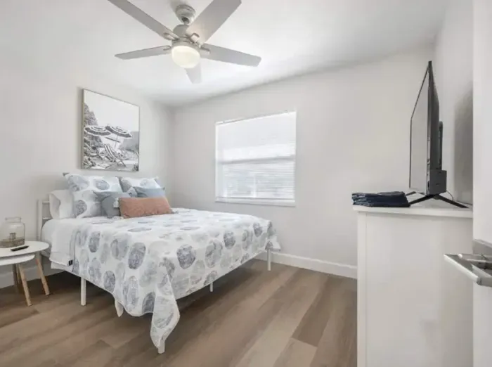 Inviting bedroom with soft coastal décor, queen bed, and serene neutral tones. Enjoy natural light, plush bedding, and modern furnishings that create a peaceful retreat ideal for rest and relaxation.