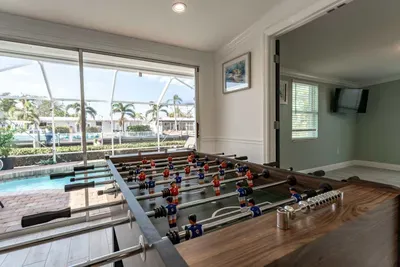 Enjoy friendly competition on the foosball table while soaking in the stunning pool view. Perfect for both relaxation and entertainment, this space offers the best of both worlds.