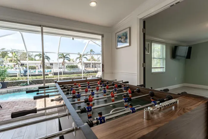Enjoy friendly competition on the foosball table while soaking in the stunning pool view. Perfect for both relaxation and entertainment, this space offers the best of both worlds.