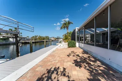 Enjoy your own peaceful retreat with a private backyard that leads to a serene canal. Relax by the water, fish off the dock, or simply take in the stunning views. The perfect spot to unwind and connect with nature.