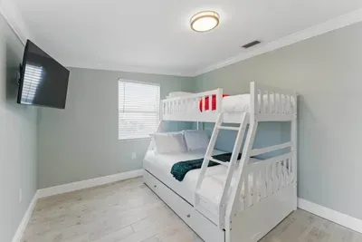 This double deck bed, paired with a wide TV, is perfect for guests who love to relax in style. Ideal for kids or anyone looking for a unique, cozy sleeping experience with a touch of entertainment.