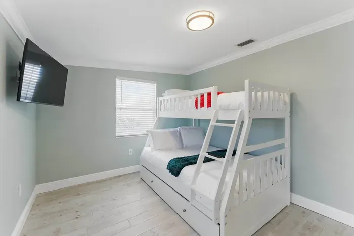 This double deck bed, paired with a wide TV, is perfect for guests who love to relax in style. Ideal for kids or anyone looking for a unique, cozy sleeping experience with a touch of entertainment.