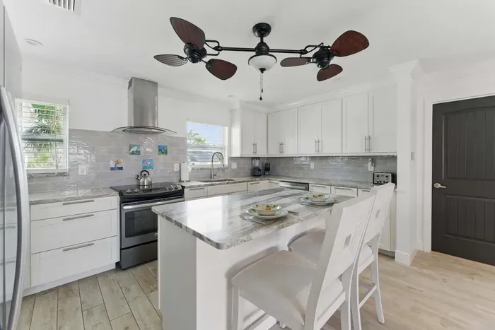 Cook with ease in this modern kitchen, complete with spacious counters, a full-size fridge, stove, microwave, coffee maker, and all the essentials to feel right at home.