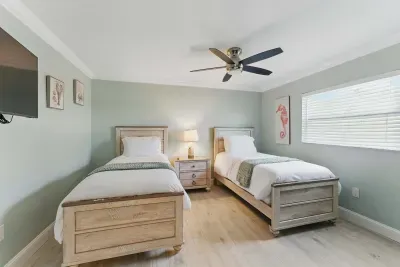 Relax in this cozy twin bedroom, featuring a comfortable single bed and a wide flat-screen TV for your entertainment. Perfect for a restful night’s sleep or catching up on your favorite shows.