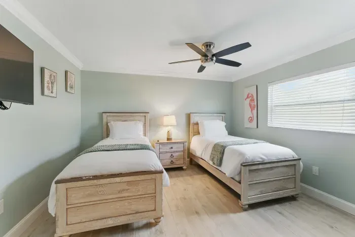Relax in this cozy twin bedroom, featuring a comfortable single bed and a wide flat-screen TV for your entertainment. Perfect for a restful night’s sleep or catching up on your favorite shows.