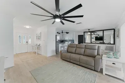 Relax in the roomy, inviting living area featuring a comfortable, wide couch perfect for lounging after a day of adventure.