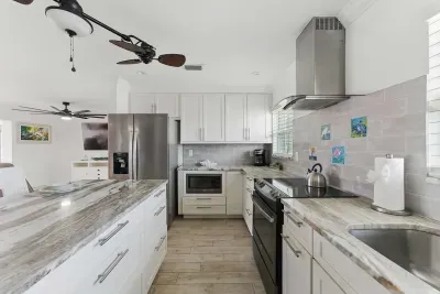 Enjoy a bright, open kitchen outfitted with all the must-haves: wide countertops, a refrigerator, dishwasher, coffee machine, and more.