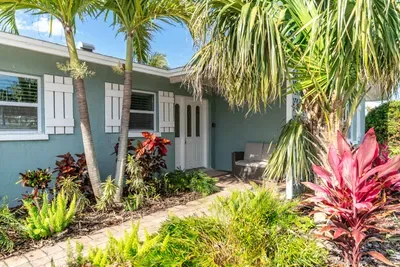 This home greets you with a charming entrance framed by vibrant landscaping and tropical touches the perfect first impression. Lush greenery, manicured paths, and a welcoming vibe set the tone for a relaxing and memorable stay.