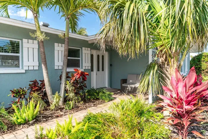 This home greets you with a charming entrance framed by vibrant landscaping and tropical touches the perfect first impression. Lush greenery, manicured paths, and a welcoming vibe set the tone for a relaxing and memorable stay.