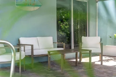 Unwind in comfort on this inviting outdoor patio, designed for both relaxation and entertaining, with plenty of space to enjoy the outdoors in style.