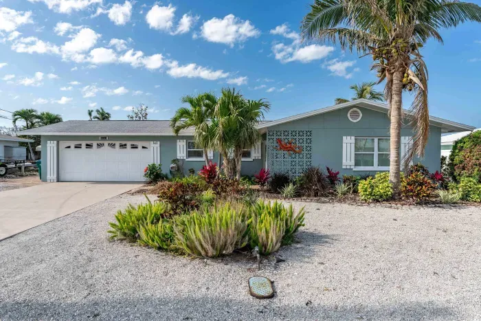 Welcome to your home away from home! The front exterior of this charming property is sure to make an impression, with its inviting entryway and lush landscaping.