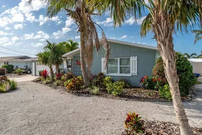 Discover the peaceful side of this beautiful property! The side exterior offers a hidden gem with a private garden, shaded nooks, and a cozy outdoor seating area perfect for quiet moments of relaxation.