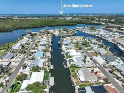 This stunning aerial view says it all — your vacation home is nestled on a peaceful canal just minutes from the world-famous Anna Maria Island! Enjoy quick access to white-sand beaches, vibrant local dining, and unforgettable sunsets.