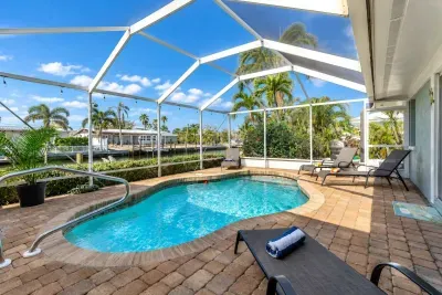 This sparkling pool is surrounded by comfy lounge chairs, tropical landscaping, and tranquil canal views all framed by a spacious lanai. Whether you're sipping morning coffee poolside or enjoying an evening swim under the string lights.