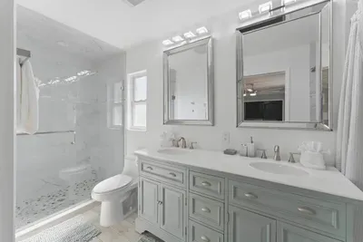 Indulge in the comfort of this spacious bathroom, featuring a sleek double vanity for plenty of room to get ready in style. The wide, open shower offers a relaxing and refreshing space, while the separate toilet area ensures privacy and convenience.