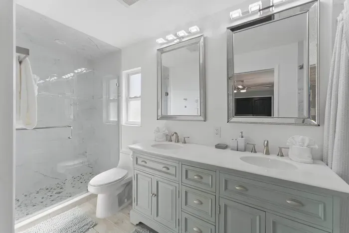 Indulge in the comfort of this spacious bathroom, featuring a sleek double vanity for plenty of room to get ready in style. The wide, open shower offers a relaxing and refreshing space, while the separate toilet area ensures privacy and convenience.
