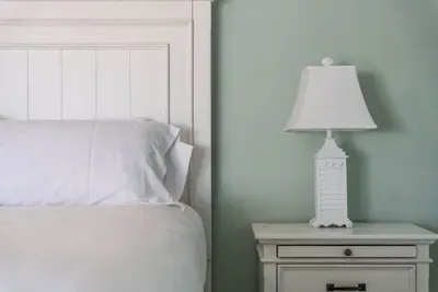 This bedside table with a stylish lamp adds the perfect touch of comfort and practicality to your room. Perfect for keeping essentials close and adding a soft glow for nighttime relaxation.