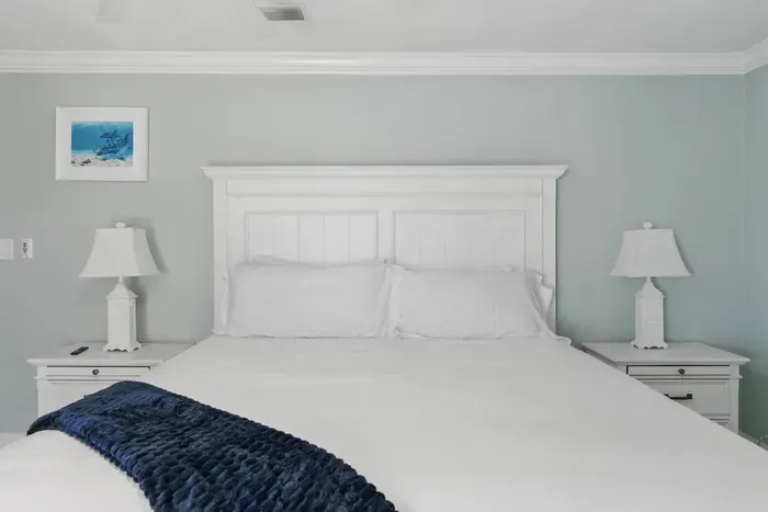 Relax in this inviting queen-sized bed, flanked by two stylish side tables with lamps for reading or setting your essentials. A perfect blend of comfort and functionality.
