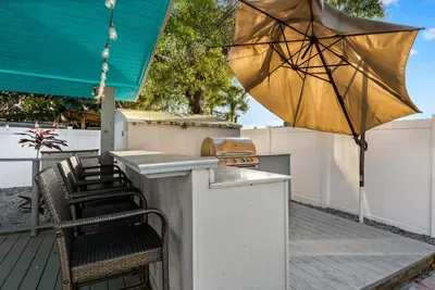 Outdoor bar and grill area with plenty of shade to enjoy with family and friends.