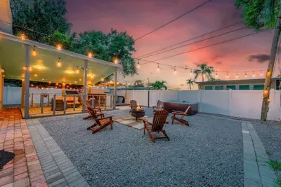 Enjoy evenings under twinkling string lights with a firepit, lounge chairs, and outdoor bar seating. Perfect for relaxing sunsets, BBQs, or stargazing in a peaceful, private space that invites connection and comfort.