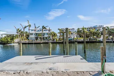 Private boat dock with direct canal access, perfect for boating, fishing, or waterfront relaxation. Enjoy serene views and easy access to open waters from your own tropical retreat.