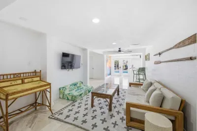 Bright game and lounge area featuring tropical-inspired décor, arcade games, and comfy seating. Perfect for family fun or relaxing after a day on the water—this playful space brings vacation vibes indoors.