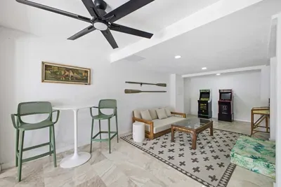 Fun-filled game lounge featuring retro arcade machines, cozy seating, and a stylish bar area. Perfect for family entertainment or friendly competition, this bright and modern space adds excitement and relaxation to your coastal vacation stay.