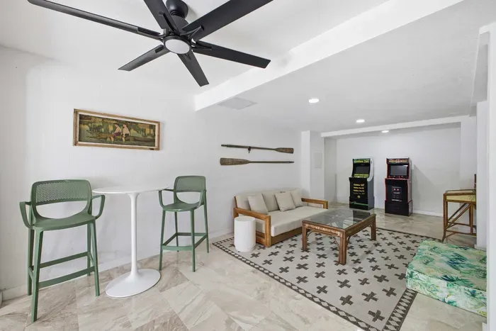 Fun-filled game lounge featuring retro arcade machines, cozy seating, and a stylish bar area. Perfect for family entertainment or friendly competition, this bright and modern space adds excitement and relaxation to your coastal vacation stay.