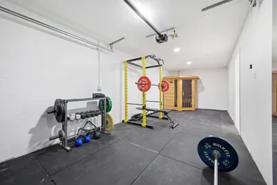 Spacious private gym with power rack, free weights, and ample room for full workouts. Clean, well-lit, and fully equipped for strength training or daily fitness routines—perfect for staying active without leaving the comfort of home.