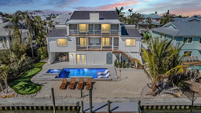 Stunning waterfront home with private pool, spacious patio, and multiple balconies. Enjoy sunset views, outdoor dining, and direct water access. A perfect coastal escape blending luxury, comfort, and unforgettable scenery.