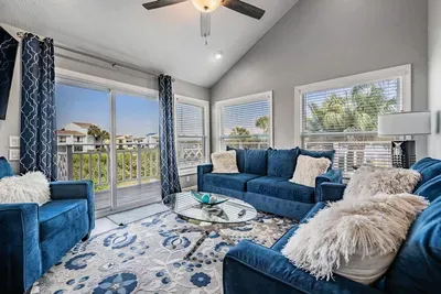 Stylish second living room featuring plush seating, chic décor, and large windows flooding the space with natural light. Perfect for quiet relaxation, reading, or sipping morning coffee with serene views.
