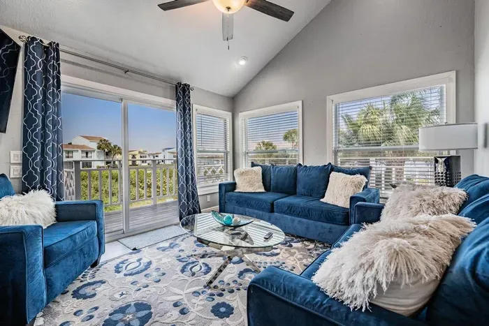 Stylish second living room featuring plush seating, chic décor, and large windows flooding the space with natural light. Perfect for quiet relaxation, reading, or sipping morning coffee with serene views.