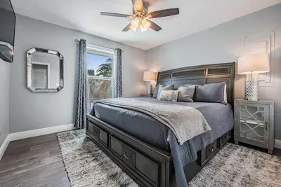Bedroom 2 offers a serene retreat with a plush king bed, stylish décor, and cozy bedding. Natural light fills the space, creating a relaxing atmosphere—perfect for restful nights and peaceful mornings.
