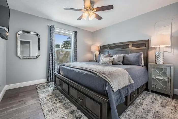Bedroom 2 offers a serene retreat with a plush king bed, stylish décor, and cozy bedding. Natural light fills the space, creating a relaxing atmosphere—perfect for restful nights and peaceful mornings.
