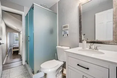 Modern master ensuite featuring a sleek vanity, walk-in shower with frosted glass, and stylish finishes. Designed for comfort and privacy, this bathroom offers a refreshing space to start your day or unwind in relaxation.