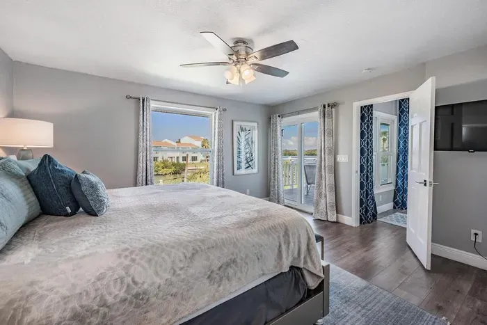 Bedroom 4 offers a king bed retreat with private balcony access, where guests can wake up to fresh air and serene views. Bright, modern décor and cozy details make this space perfect for relaxation and restful nights.