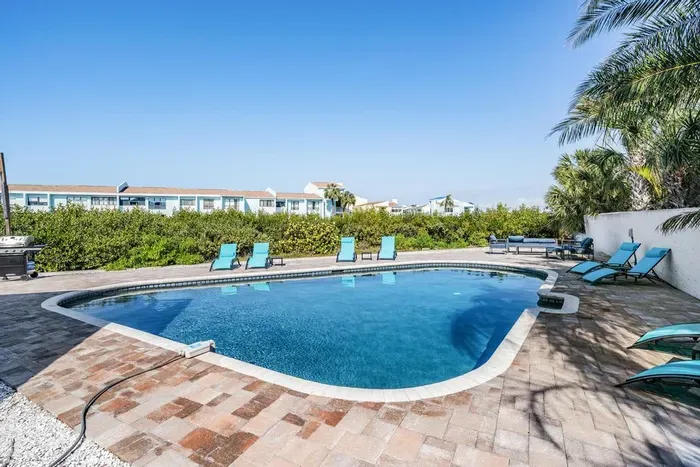 Dive into relaxation! This sparkling private pool is surrounded by palm trees, lounge chairs, and plenty of space to soak up the sun. Ideal for refreshing swims, family fun, or unwinding with a drink in hand.