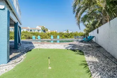 Practice your swing on the private putting green just steps from the pool! Surrounded by palms and sunshine, this fun feature makes the outdoor space perfect for both relaxation and play. Ideal for families & golf lovers alike!